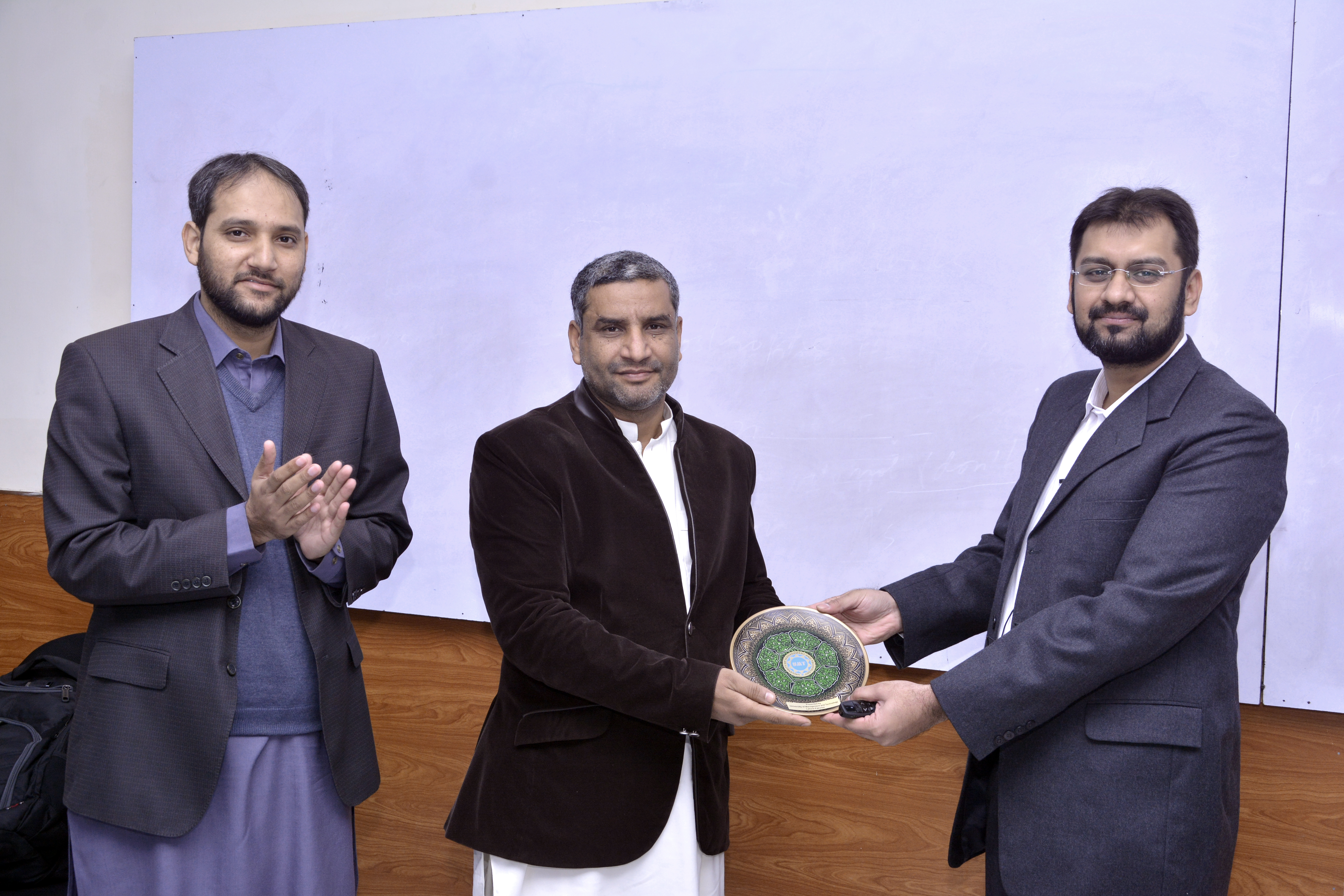 Dean SST Dr. Shoukat Iqbal Presenting souvenir to Dr. Safee Ullah Chaudhry