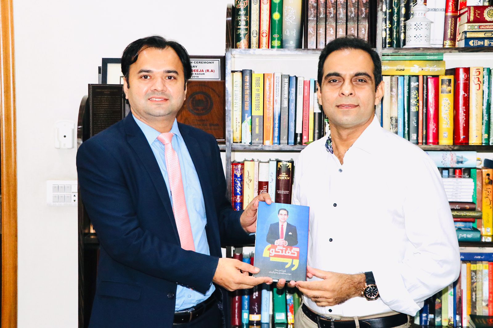 Qasim Ali Shah presenting his book to CLO